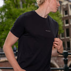 model walking wearing a black merino wool t-shirt
